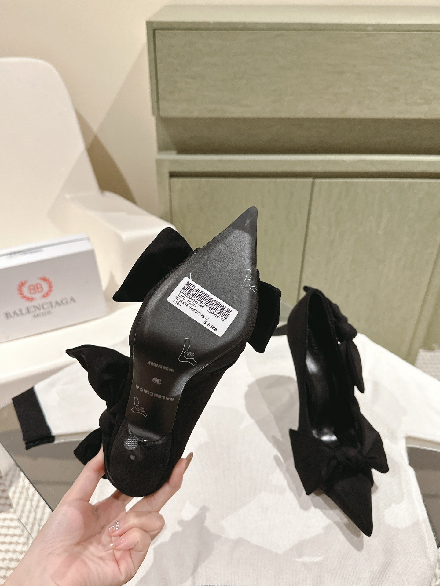 Black high-heel sandals with bow detail and branded insole at heel