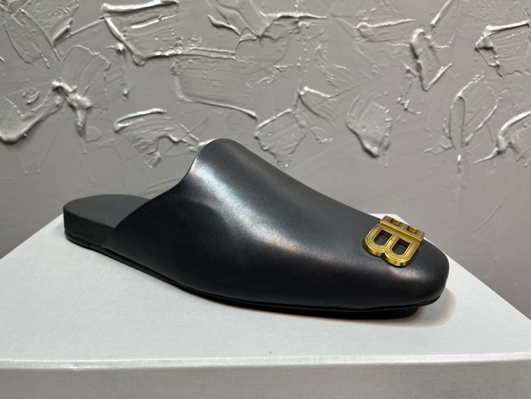 Black slide sandal with curved toe and gold BB logo on the outer strap.