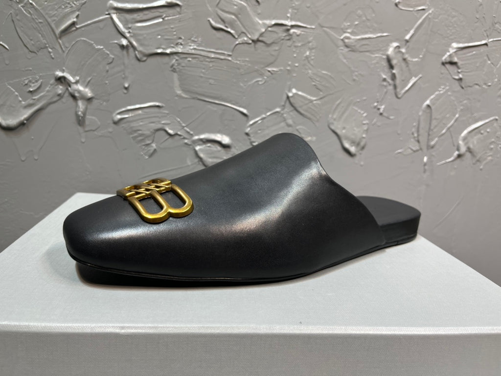 Black leather slide sandal with gold B-logo on strap, low sole