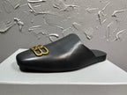 Black leather slide sandal with gold B-logo on strap, low sole