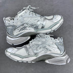 Balenciaga unisex sneakers pair in light silver-gray with lace-up and molded sole.