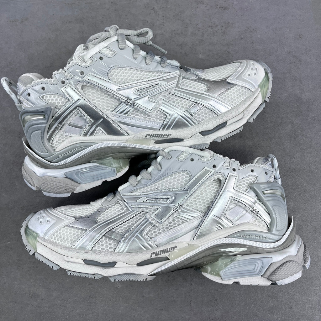 Balenciaga unisex sneakers in silver-gray with mesh panels and lace-up front.
