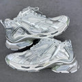 Balenciaga unisex sneakers in silver-gray with mesh panels and lace-up front.