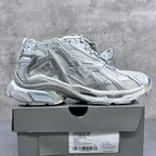 Balenciaga unisex sneakers on a shoe box, silver-gray lace-up design.