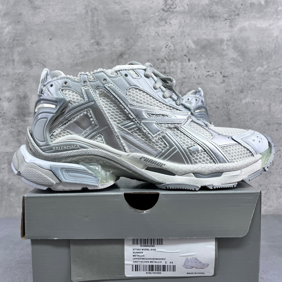 Balenciaga unisex sneakers on a shoe box, silver-gray lace-up design.