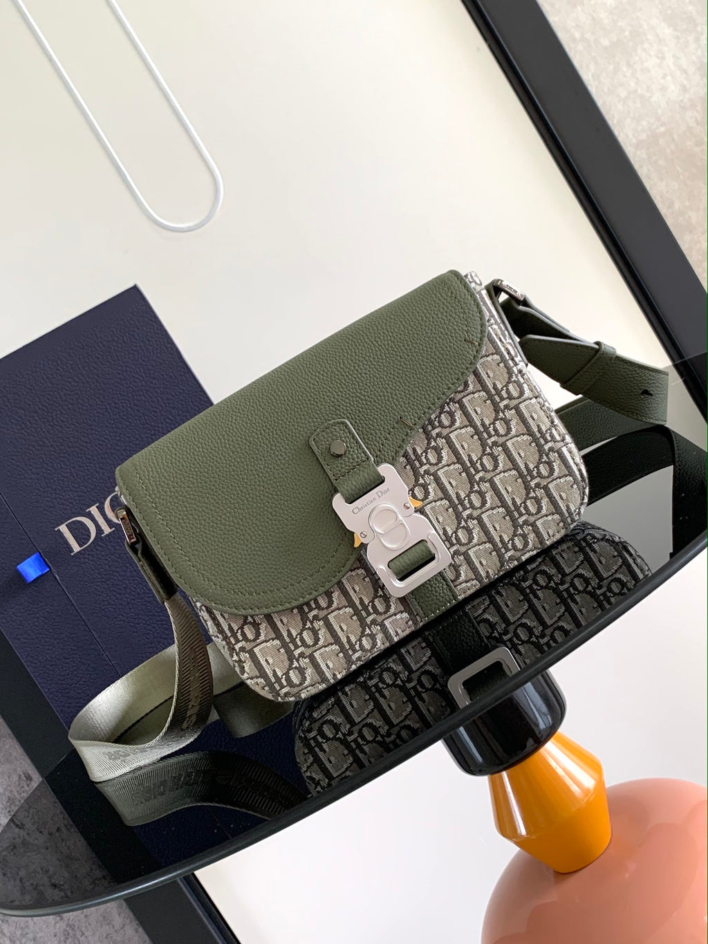 Olive green pebbled leather Dior men's bag with fold-over flap and monogram canvas front