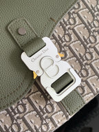 Close-up of olive leather bag hardware and Dior logo charm on monogram canvas