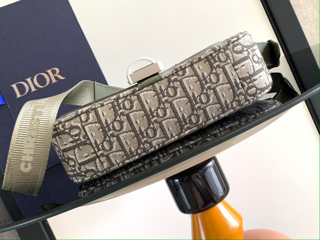 Dior bag with Dior logo canvas exterior and textured trim, gold-tone hardware at top.
