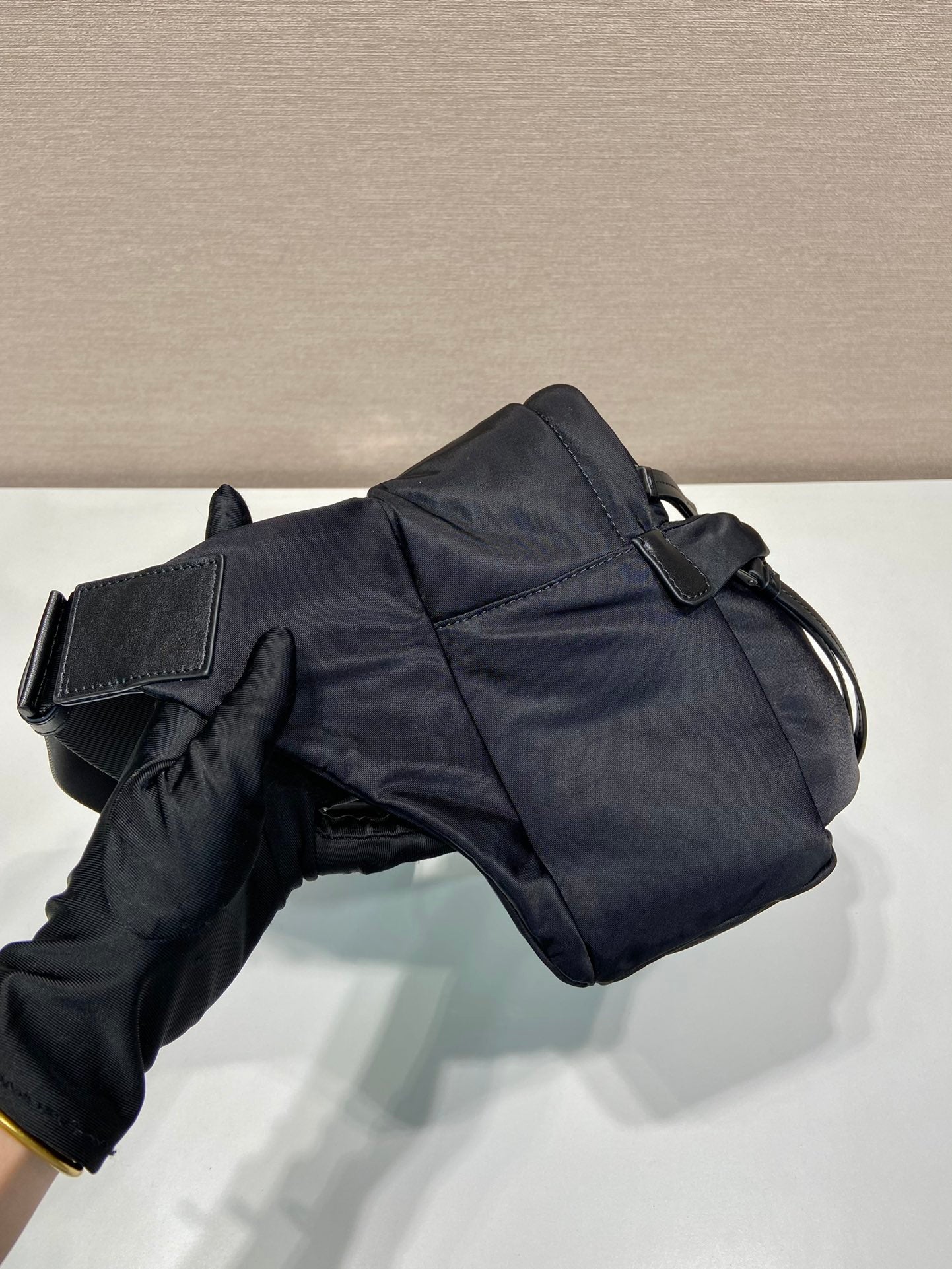 Prada black nylon shoulder bag with flap front, snap straps, and side seams