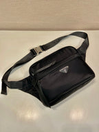 Prada black crossbody bag with front flap, silver zipper, and leather trim