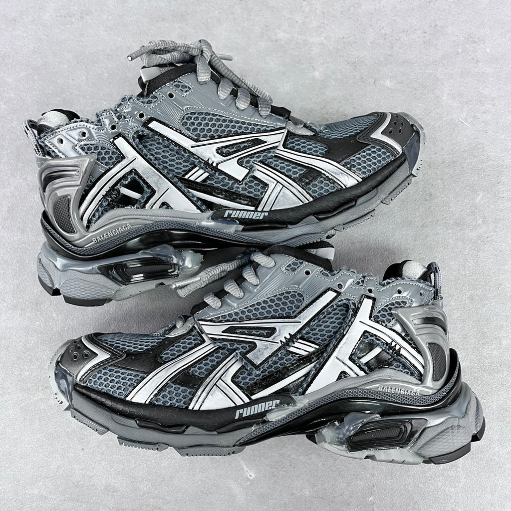 Chunky unisex sneakers with light gray mesh uppers, silver accents, and dark lace-up panels