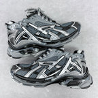 Chunky unisex sneakers with light gray mesh uppers, silver accents, and dark lace-up panels