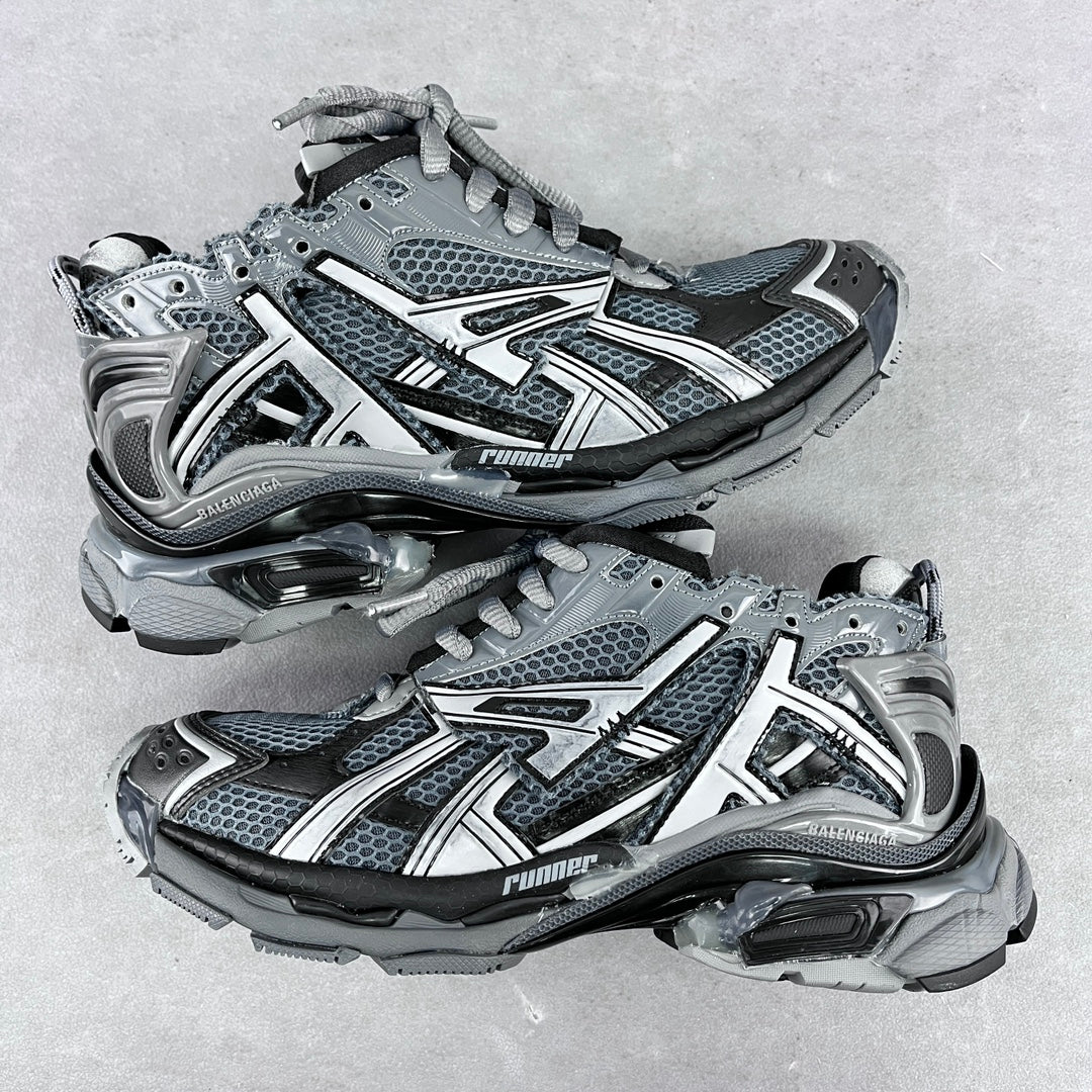 Chunky unisex sneakers with light gray mesh uppers, silver accents, and dark lace-up panels