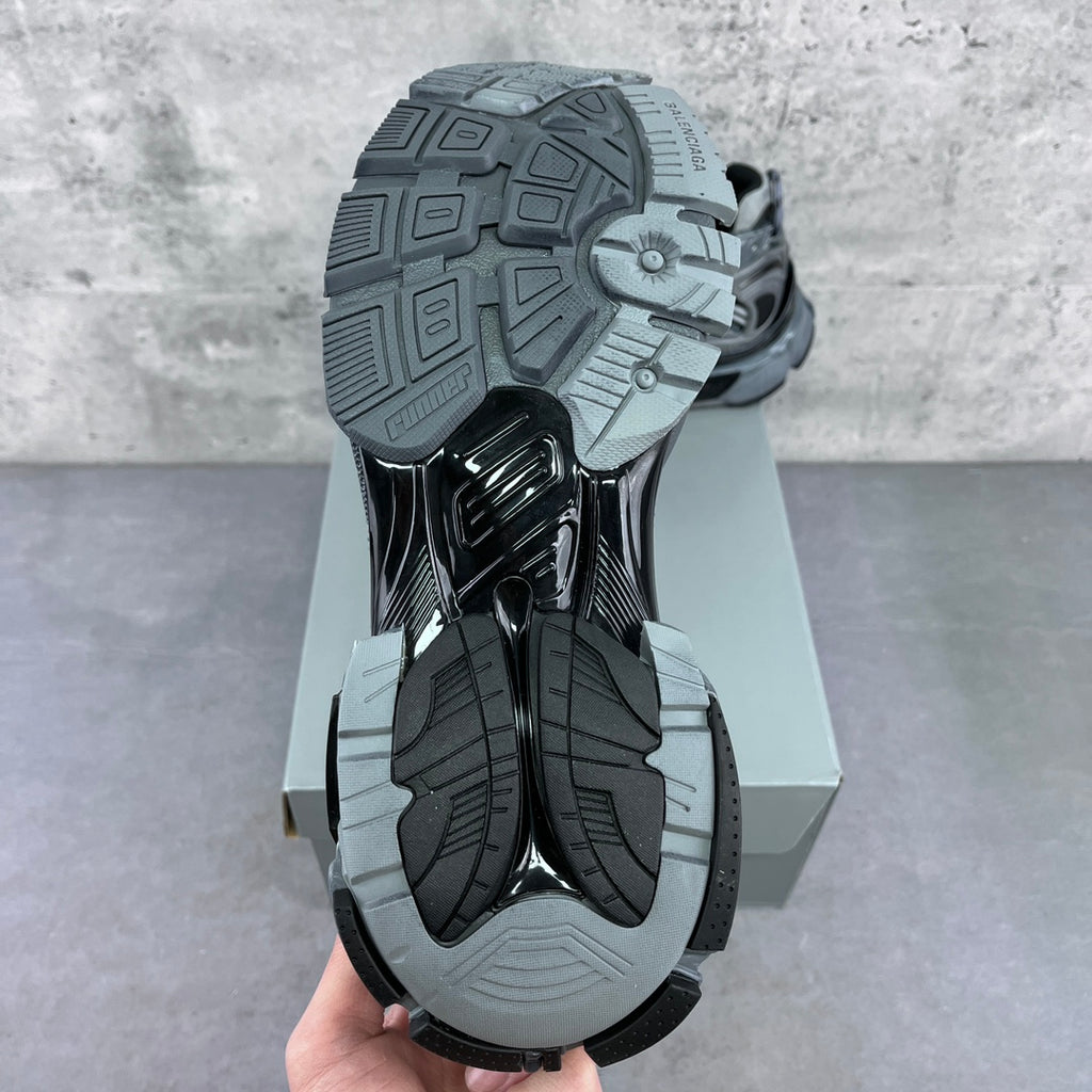 Sneaker outsole view with thick tread and molded rubber traction pattern