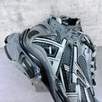 Sneaker quarter view with textured mesh, silver trim, and molded cushioned sole
