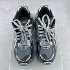 Front view of lace-up sneakers with blue-gray mesh uppers and silver and dark paneling