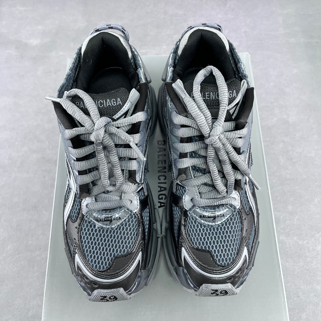 Front view of lace-up sneakers with blue-gray mesh uppers and silver and dark paneling