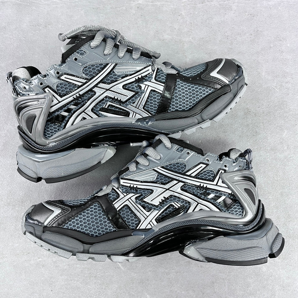Top view of chunky lace-up sneakers with blue-gray mesh, silver overlays, and thick sole