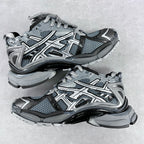 Top view of chunky lace-up sneakers with blue-gray mesh, silver overlays, and thick sole