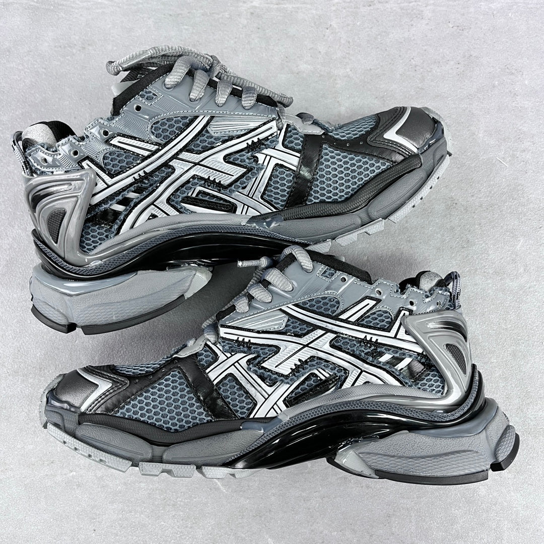Top view of chunky lace-up sneakers with blue-gray mesh, silver overlays, and thick sole