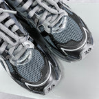 Pair of lace-up sneakers with blue-gray mesh and silver BALENCIAGA branding on the tongue