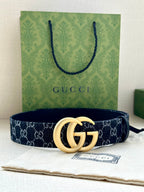 Gucci belt with dark navy GG monogram strap and oversized gold-tone double-G buckle