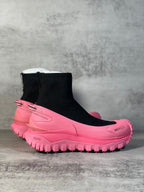 Sock boot sneaker with black knit ankle, pink midsole and chunky tread.