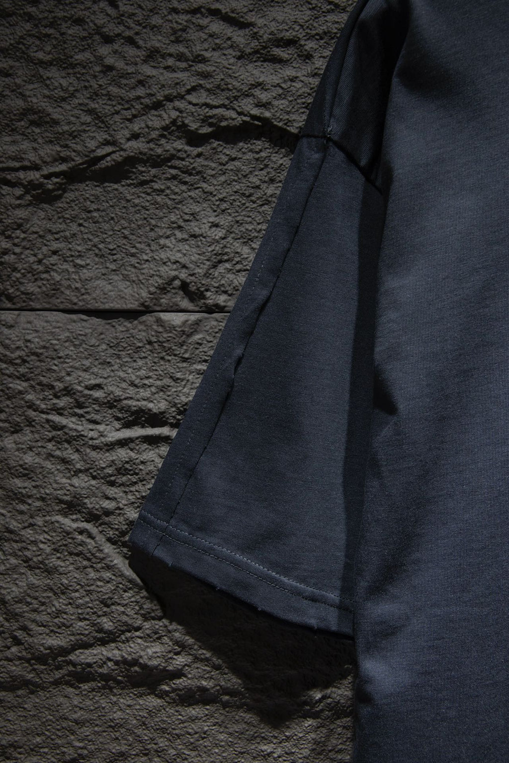 Balenciaga T-shirt side view in dark navy showing sleeve and hem stitching