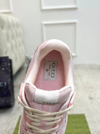 Pink Gucci sneakers inside view, showing padded collar and tongue label