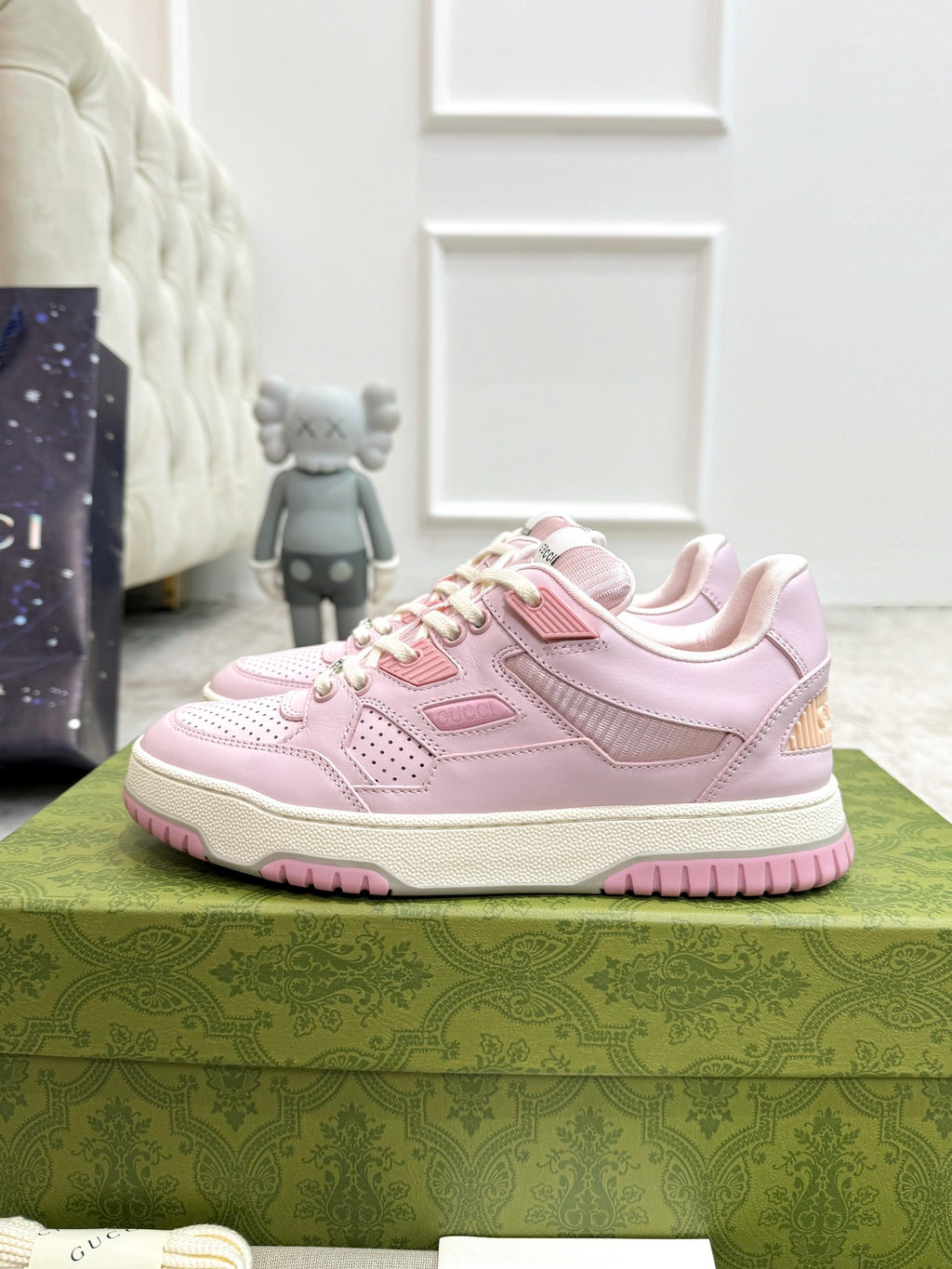 Pink Gucci lace-up sneakers, side view with perforated toe and thick sole