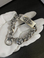 Fleur-de-lis charm bracelet with engraved center bar on white glove