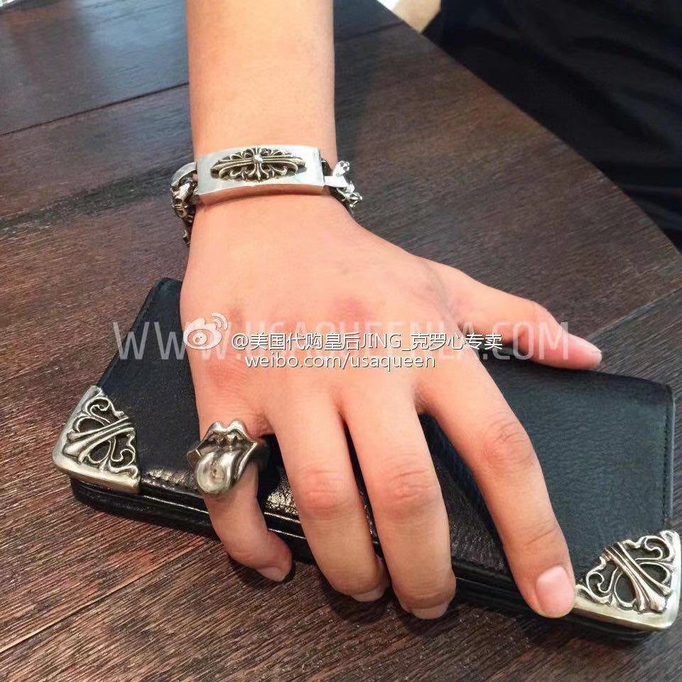 Chrome accessories bracelet with cuff-style clasp and engraved fleur-de-lis charm