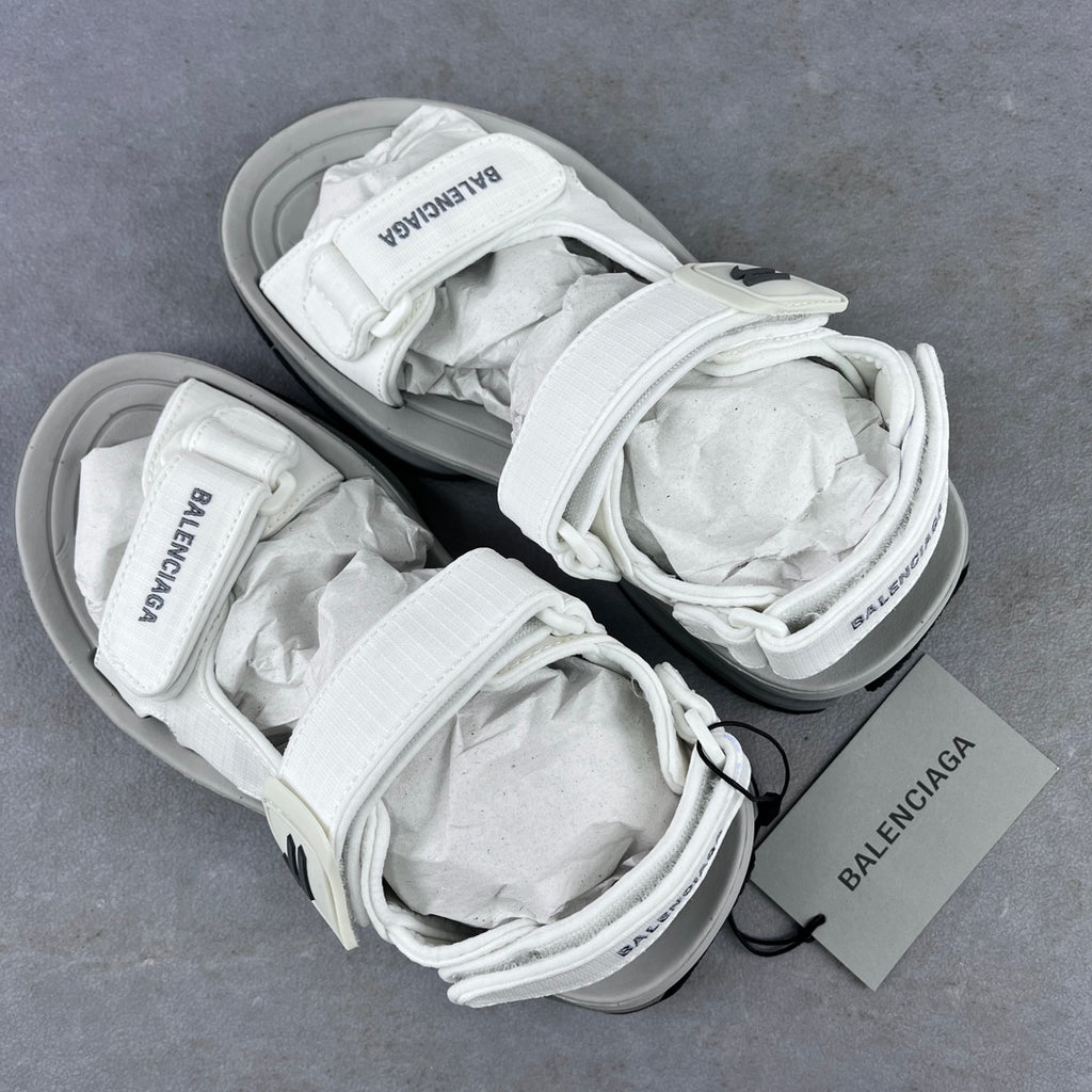 Balenciaga unisex white sandal pair on gray surface with crisscross laces