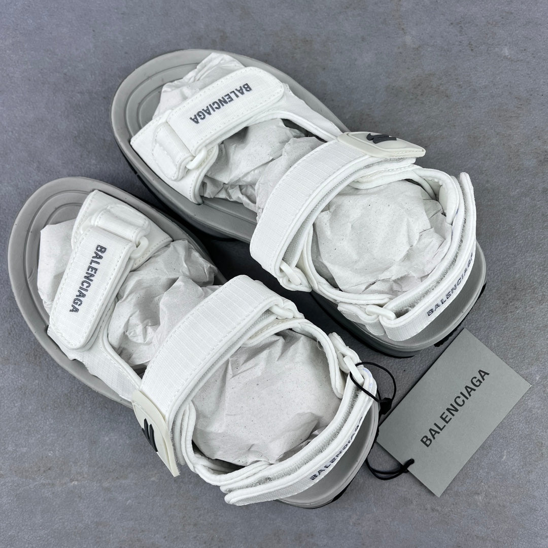 Balenciaga unisex white sandal pair on gray surface with crisscross laces