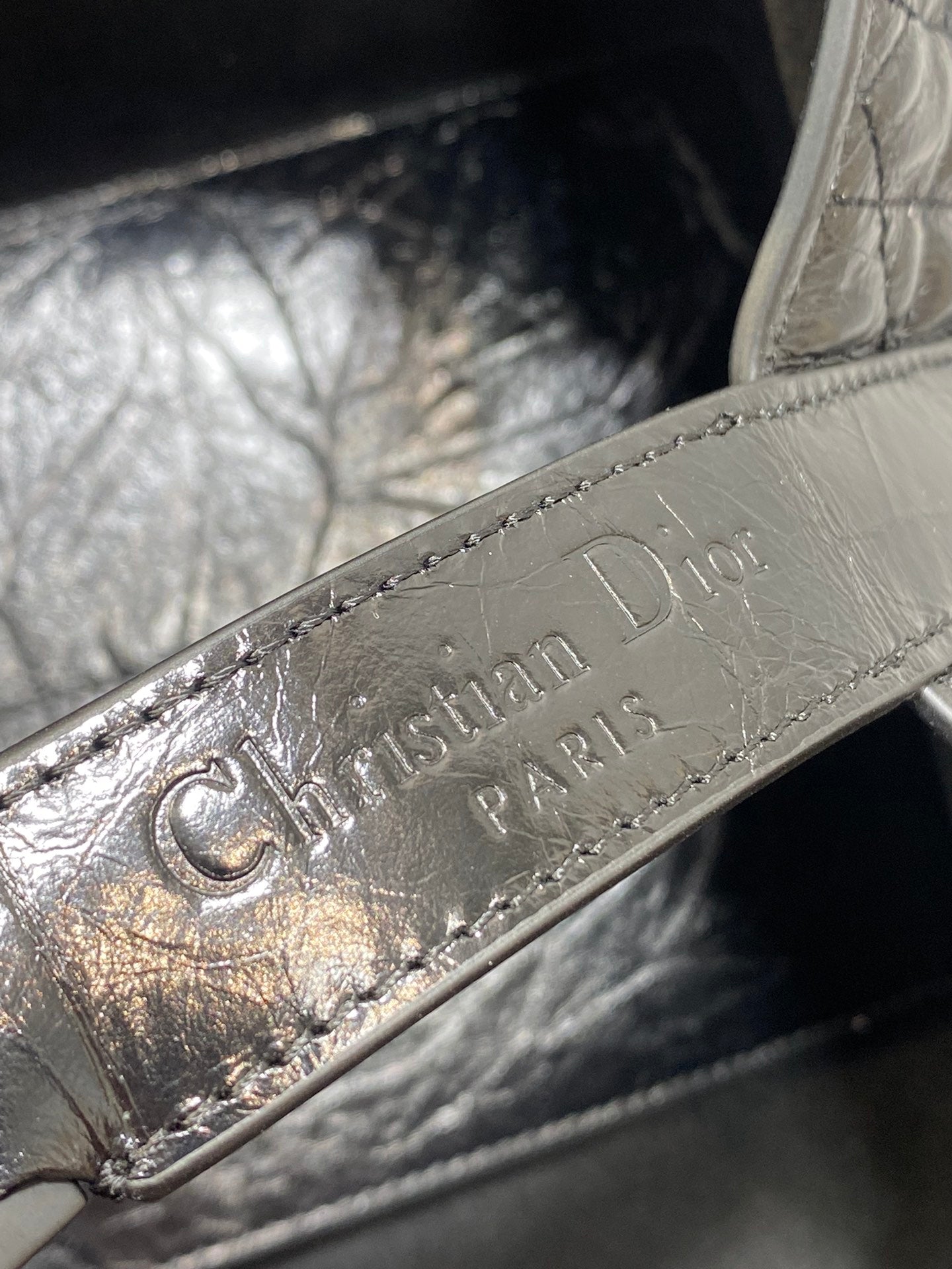 Dior logo embossed leather label inside bag, silver-tone lettering