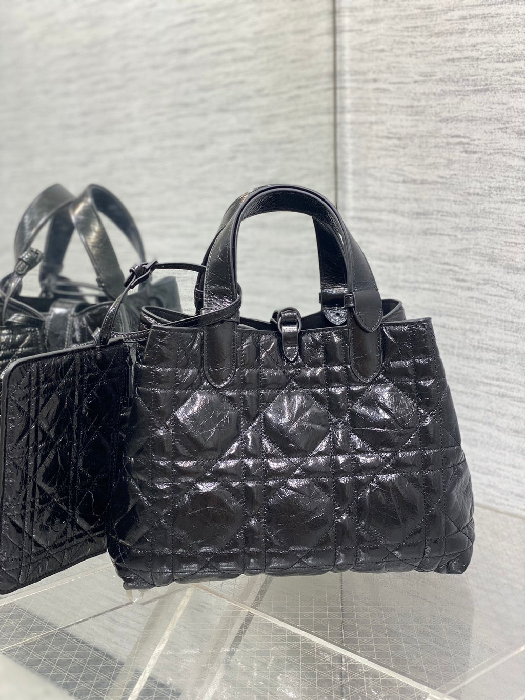 Dior tote bag with curved handles and front ring detail, quilted black finish