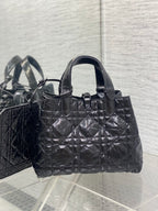 Dior tote bag with curved handles and front ring detail, quilted black finish