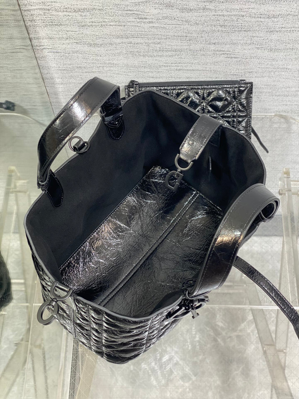 Dior bucket-style tote with adjustable shoulder strap, silver buckle hardware, black