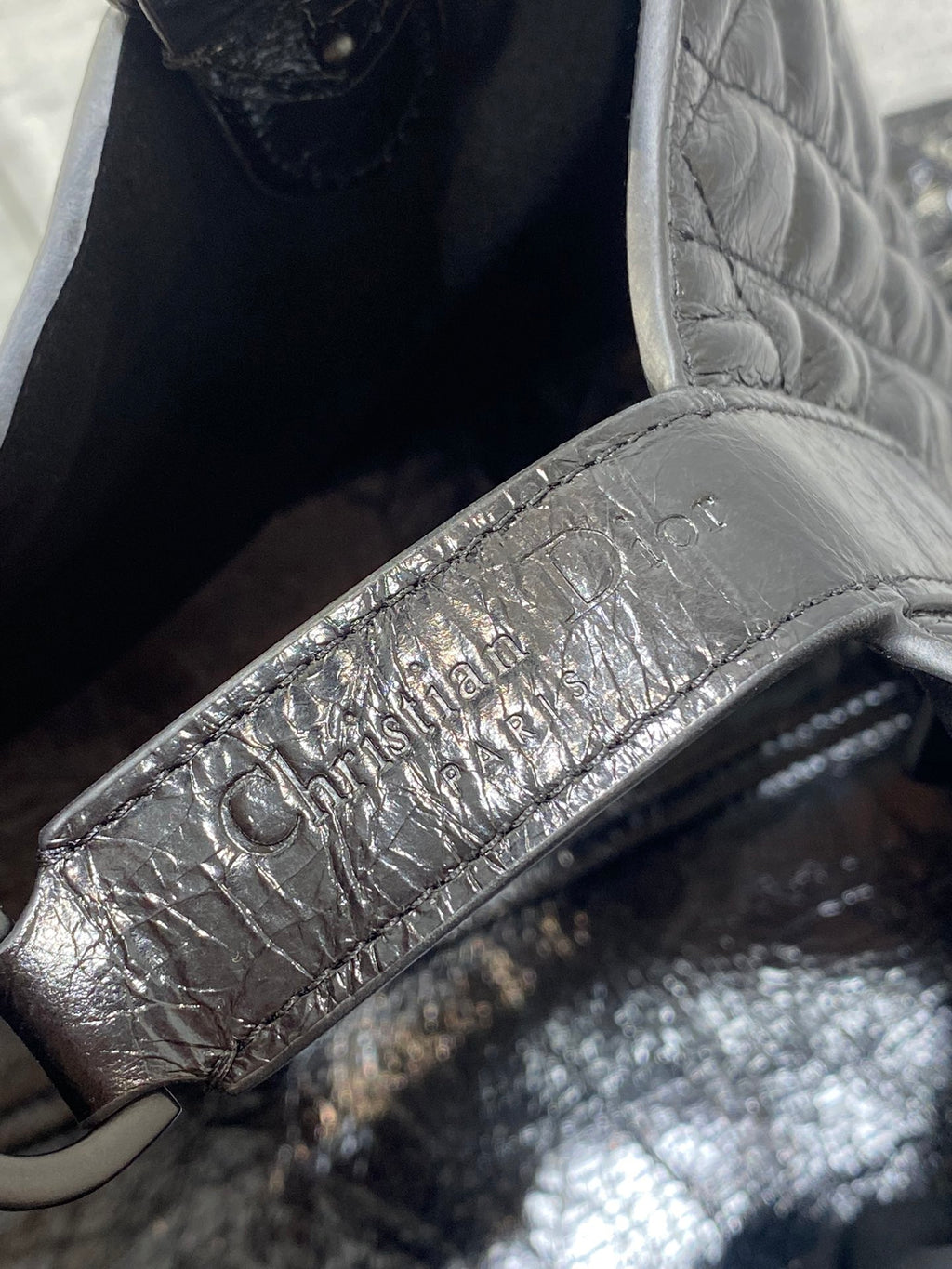 Dior leather tag on interior, embossed lettering on silver-toned fabric