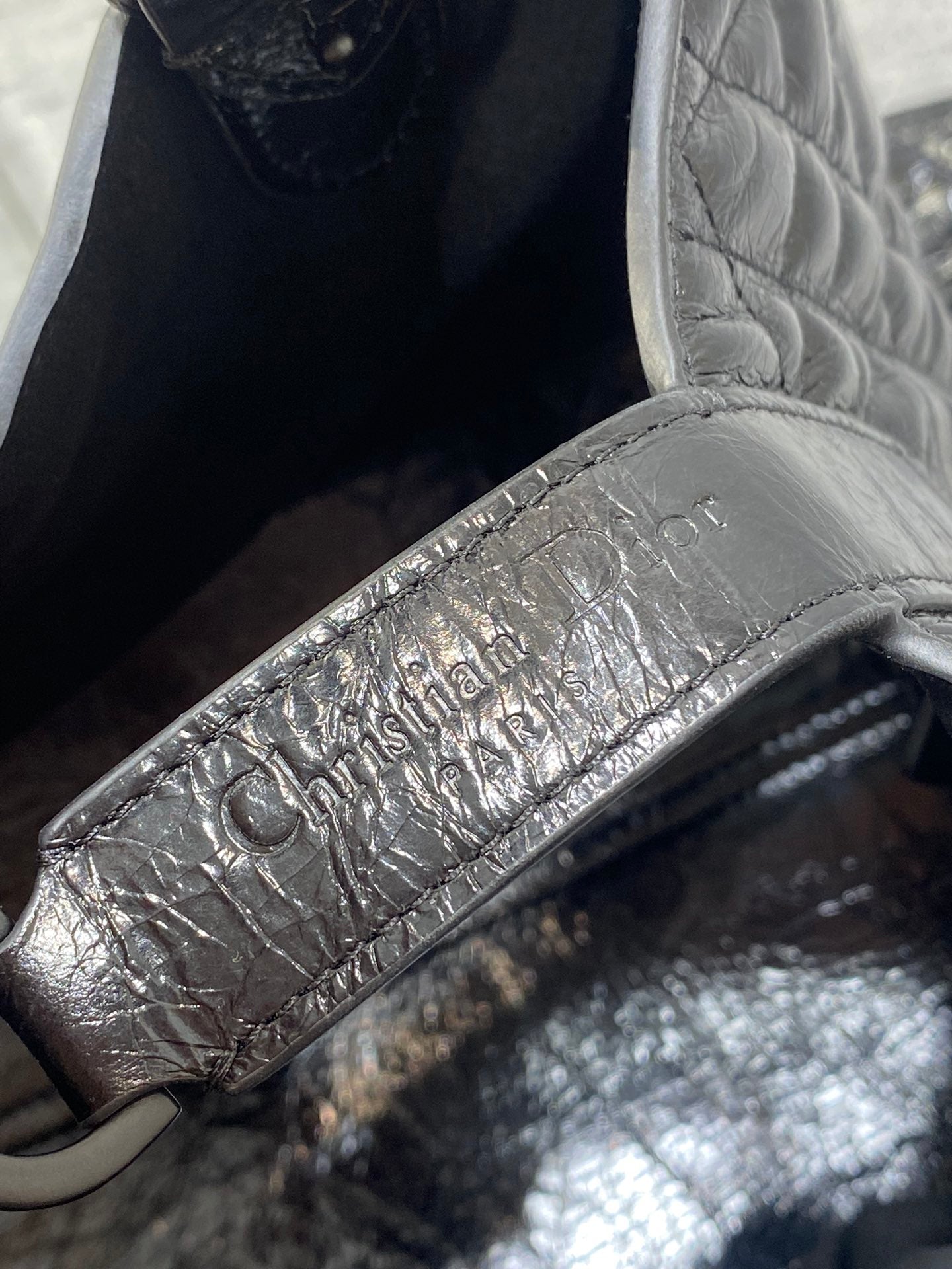 Dior leather tag on interior, embossed lettering on silver-toned fabric