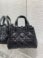 Dior tote bag front view with ring clasp, quilted texture and top handles, black