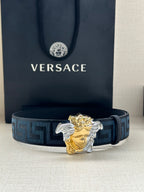 Versace belt: blue Greek-key strap with gold/silver Medusa head buckle, front view.