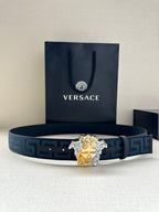 Versace belt: blue Greek-key strap with gold/silver Medusa head buckle.