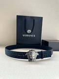 Versace belt with blue patterned strap and silver Medusa-style buckle, on display.
