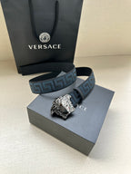 Versace belt with blue geometric pattern strap and silver Medusa buckle, shown with box.