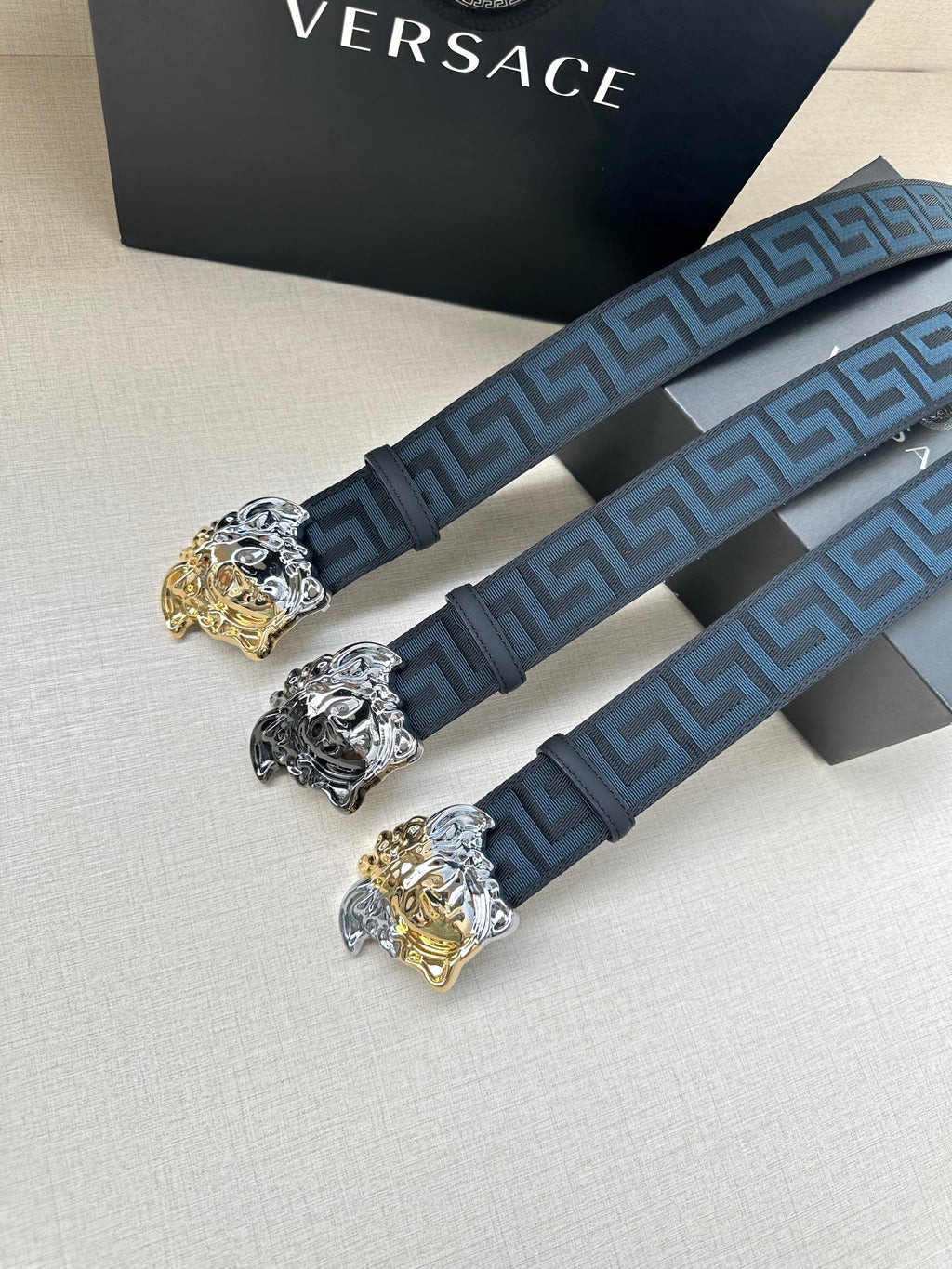 Pair of dark blue Greca belts with gold and silver Medusa buckle details