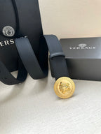 Navy leather belt with round silver medallion buckle and adjustable strap