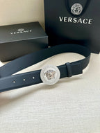 Navy leather belt with round silver medallion buckle and side hole spacing