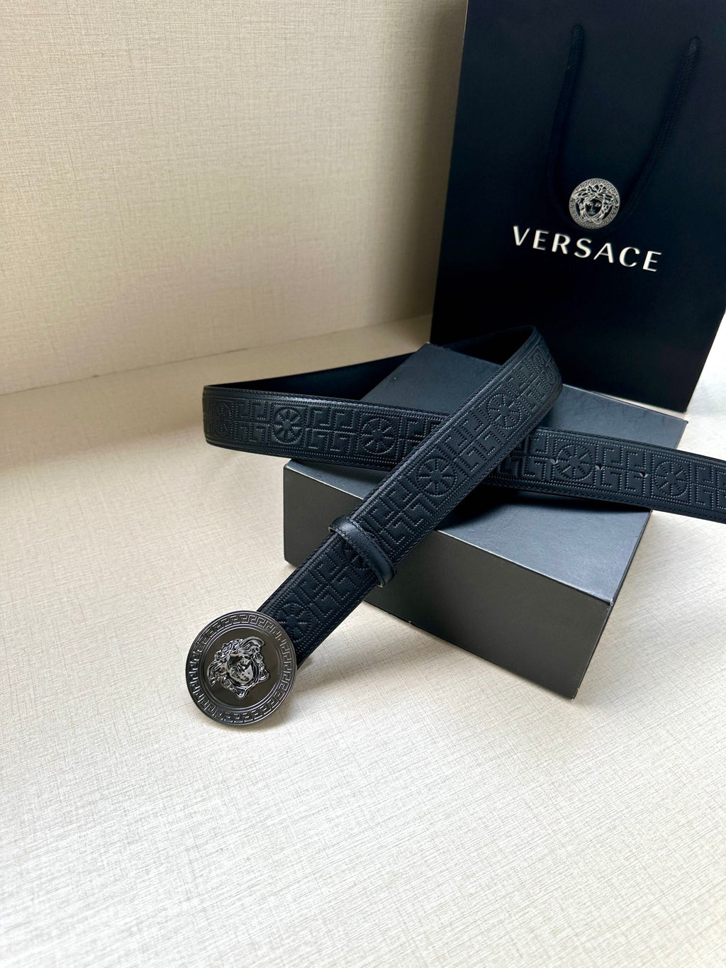 Versace belt, dark blue with embossed pattern and silver round Medusa buckle.