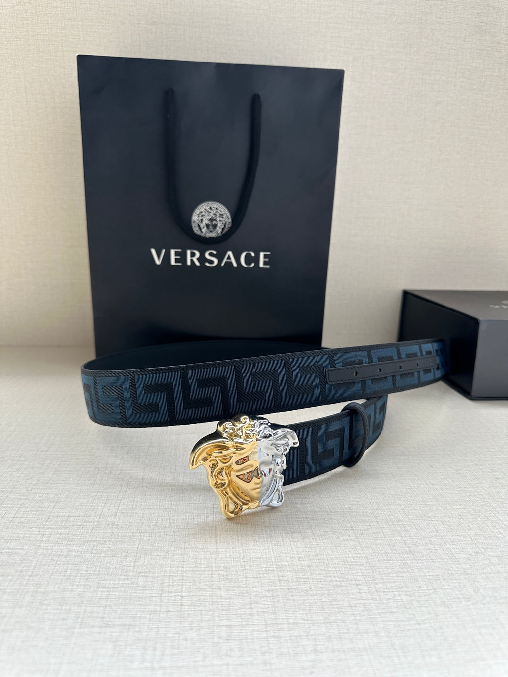 Dark blue Greca belt with gold-silver Medusa buckle and branded gift bag